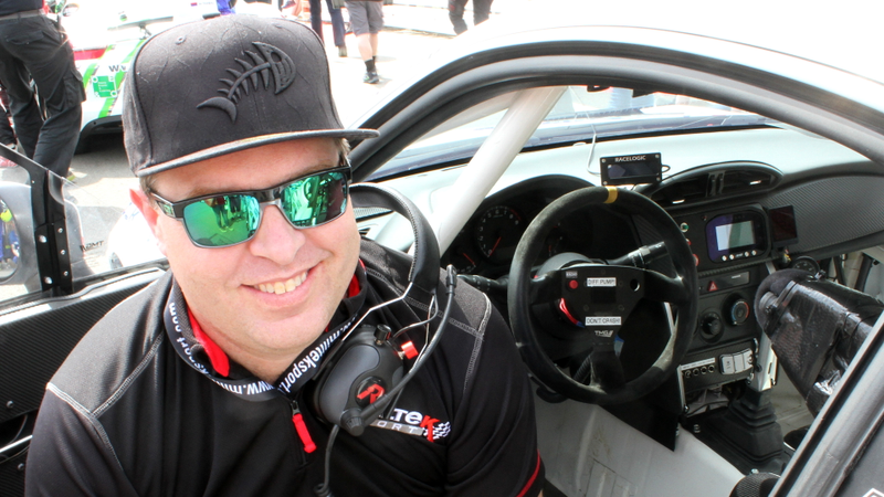 A crew member sits next to the interior of the car. There are two notes on the steering wheel: “Diff Pump” and “Don’t Crash!” The former is a label, and the latter is solid life advice in general.
